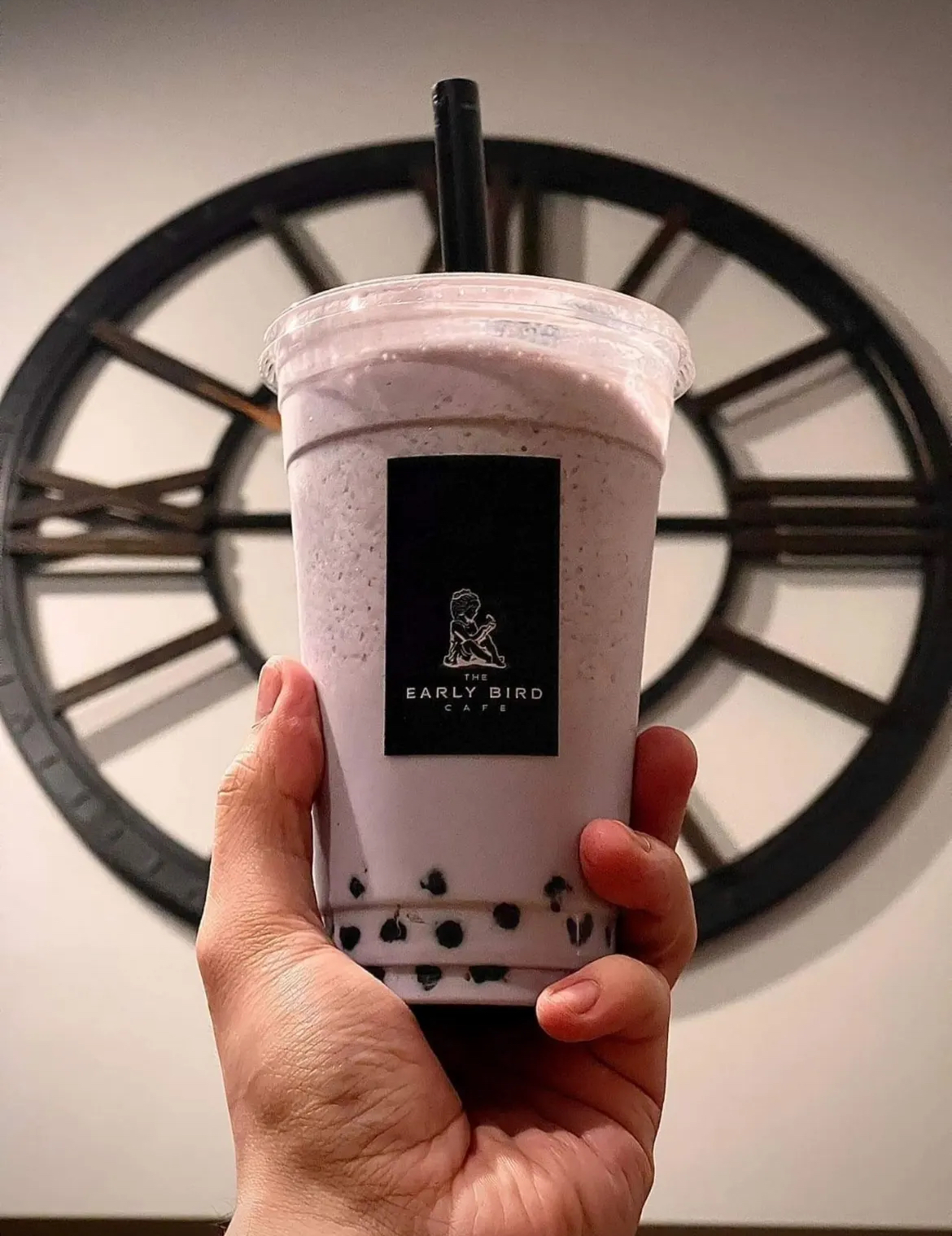 Person holding a taro boba